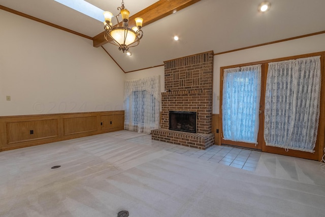 unfurnished living room with ornamental molding, beam ceiling, a brick fireplace, a chandelier, and light colored carpet