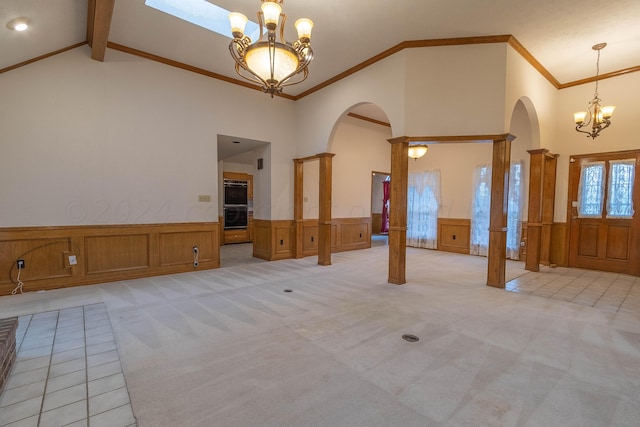 carpeted empty room with high vaulted ceiling, an inviting chandelier, ornamental molding, and beam ceiling