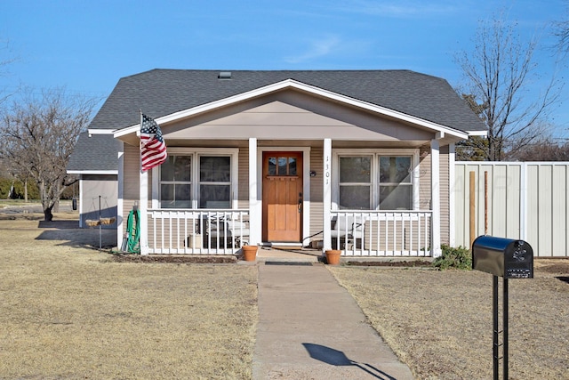 bungalow-style house with covered porch and a front yard