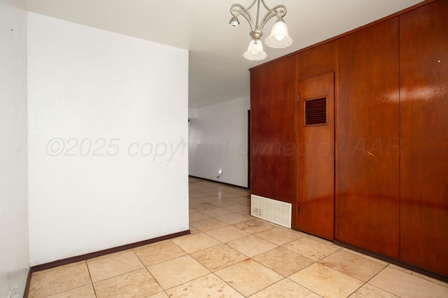 3115 Palm St, Amarillo, TX 79107 - unfurnished room featuring a chandelier, baseboards, and light tile patterned floors