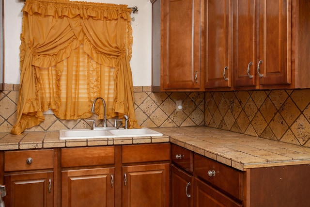 3115 Palm St, Amarillo, TX 79107 - kitchen featuring a sink, backsplash, light countertops, and brown cabinets
