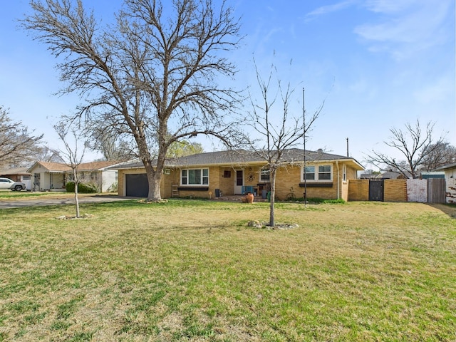 single story home with a front lawn, fence, driveway, and a garage