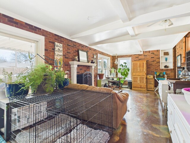 living area with a healthy amount of sunlight, finished concrete floors, and brick wall