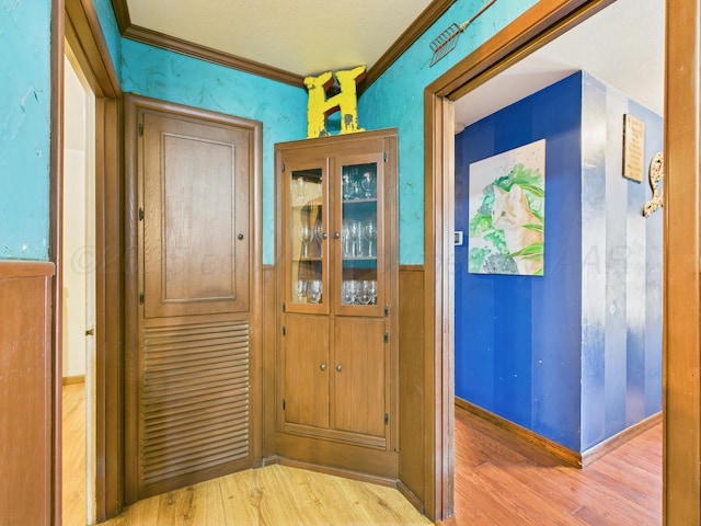 hall with crown molding and wood finished floors
