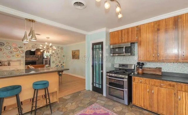 2404 S Harrison St, Amarillo, TX 79109 - kitchen featuring stainless steel appliances, brown cabinetry, ornamental molding, a kitchen breakfast bar, and tasteful backsplash