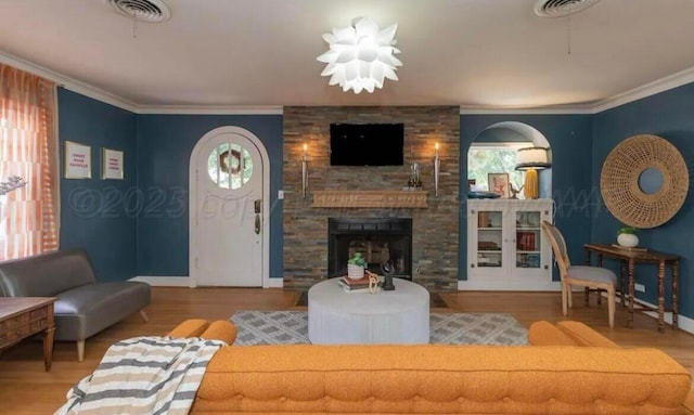 2404 S Harrison St, Amarillo, TX 79109 - living room featuring baseboards, wood finished floors, crown molding, and a fireplace