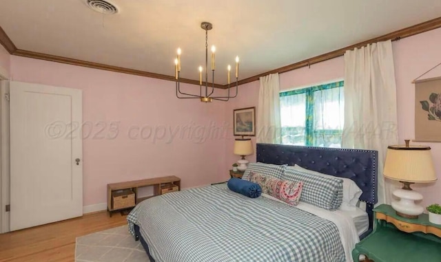 2404 S Harrison St, Amarillo, TX 79109 - bedroom with a chandelier, wood finished floors, crown molding, and baseboards
