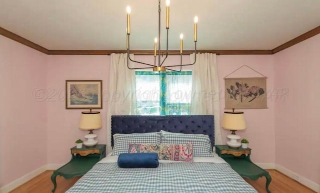 2404 S Harrison St, Amarillo, TX 79109 - bedroom featuring crown molding, baseboards, wood finished floors, and a chandelier