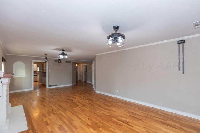 1218 N Charles St, Pampa, TX 79065 - unfurnished living room featuring light wood finished floors and ornamental molding