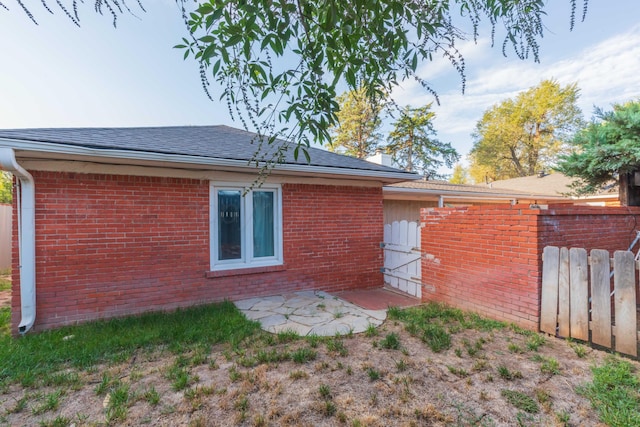 1218 N Charles St, Pampa, TX 79065 - rear view of house with brick siding and a shingled roof