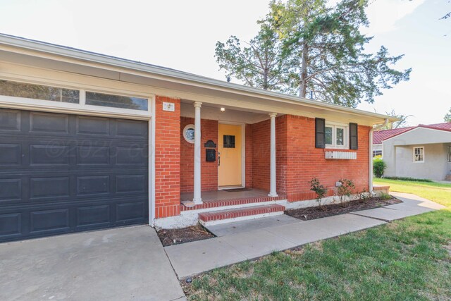 1218 N Charles St, Pampa, TX 79065 - view of front facade with brick siding, an attached garage, a porch, and driveway