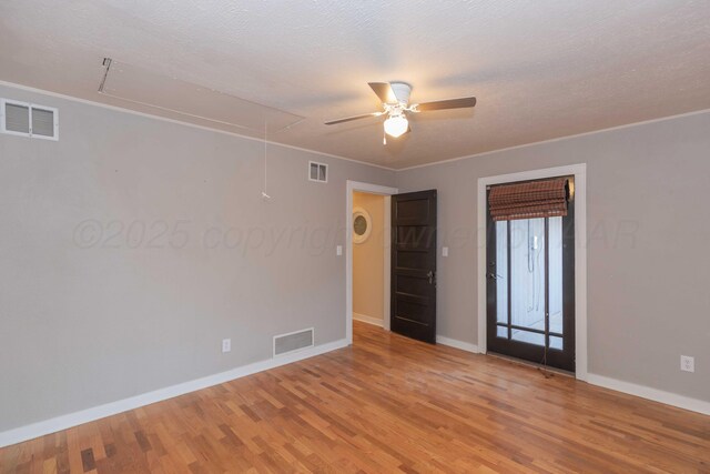 1218 N Charles St, Pampa, TX 79065 - empty room with attic access, a ceiling fan, light wood-type flooring, and ornamental molding