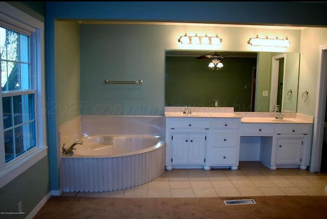 bathroom with a sink, tile patterned flooring, a garden tub, and double vanity