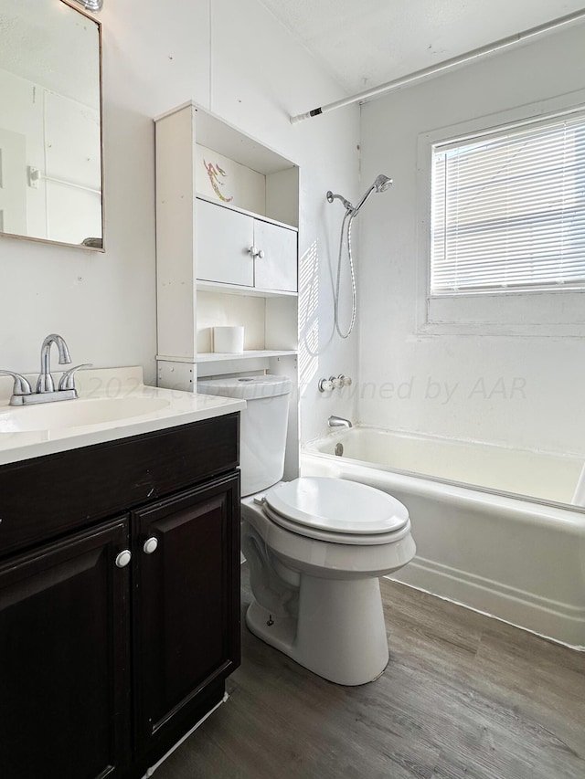 full bathroom with toilet, wood-type flooring, shower / bathing tub combination, and vanity