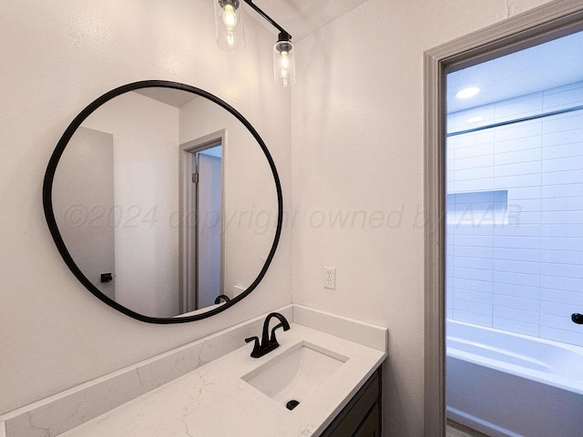 bathroom featuring vanity and tiled shower / bath combo