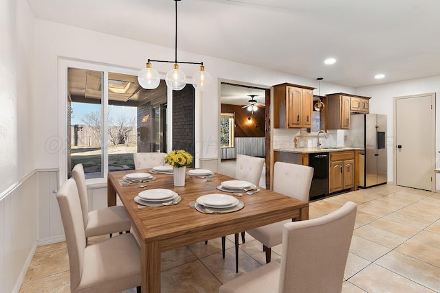 dining area featuring radiator, ceiling fan, sink, and light tile patterned flooring