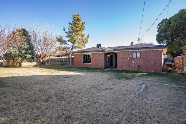 back of house featuring a yard