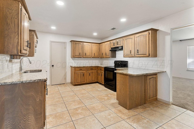 kitchen featuring black electric range oven, light carpet, sink, tasteful backsplash, and light stone counters