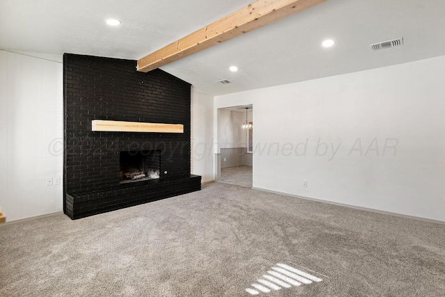 unfurnished living room with carpet flooring, vaulted ceiling with beams, and a brick fireplace