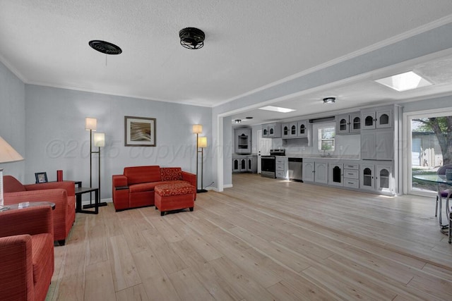 912 W Bonita Ave, Amarillo, TX 79108 - living area with crown molding, a textured ceiling, plenty of natural light, and light wood-type flooring