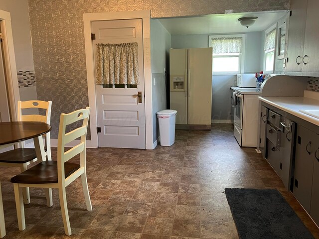 602 S Young St, Follett, TX 79034 - kitchen featuring white appliances, light countertops, and wallpapered walls