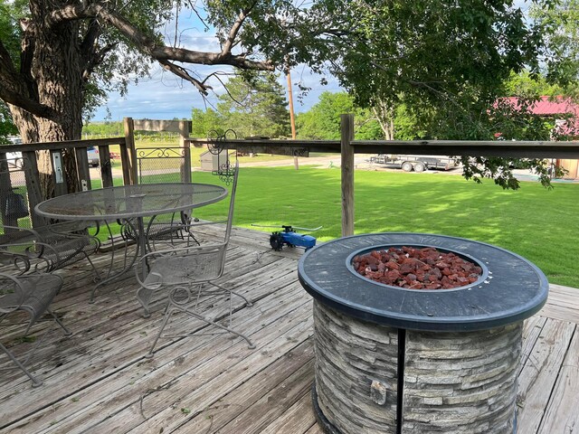 602 S Young St, Follett, TX 79034 - wooden deck with outdoor dining space, a yard, and a fire pit