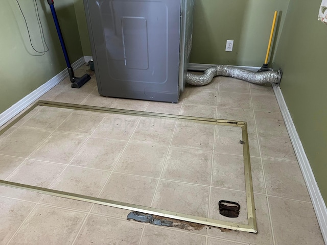 602 S Young St, Follett, TX 79034 - laundry area with tile patterned flooring, baseboards, and washer / dryer