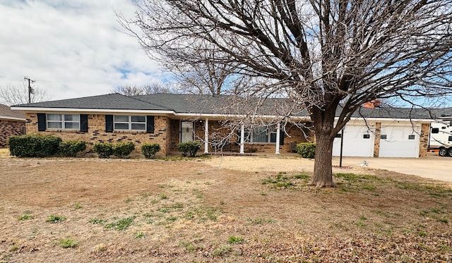 ranch-style home featuring a garage, brick siding, and concrete driveway