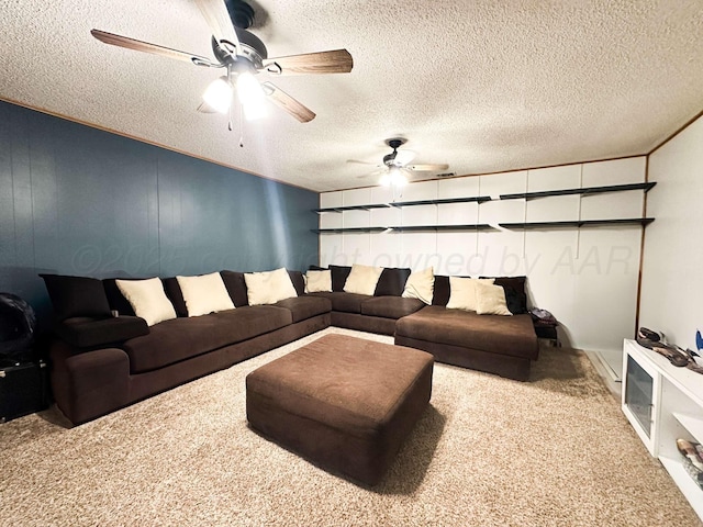 living area with carpet floors, ceiling fan, and a textured ceiling