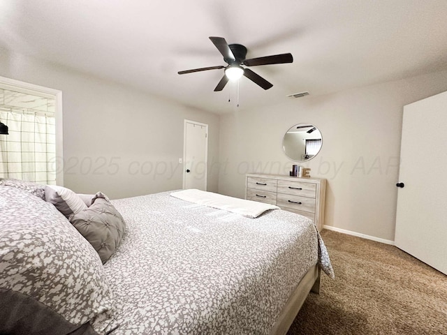carpeted bedroom with baseboards, visible vents, and ceiling fan