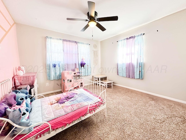 bedroom featuring carpet flooring, baseboards, multiple windows, and ceiling fan