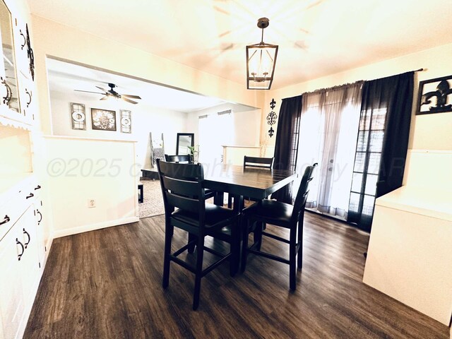 dining area featuring washer / clothes dryer, dark wood-style floors, baseboards, and ceiling fan