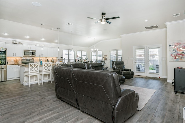 8906 Witmer Ct, Amarillo, TX 79119 - living room with ceiling fan, ornamental molding, wood finished floors, healthy amount of natural light, and a chandelier