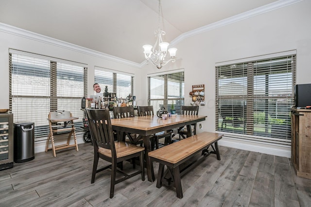 8906 Witmer Ct, Amarillo, TX 79119 - dining room with vaulted ceiling, a chandelier, crown molding, and wood finished floors
