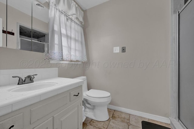 full bathroom with vanity, toilet, baseboards, tile patterned floors, and an enclosed shower