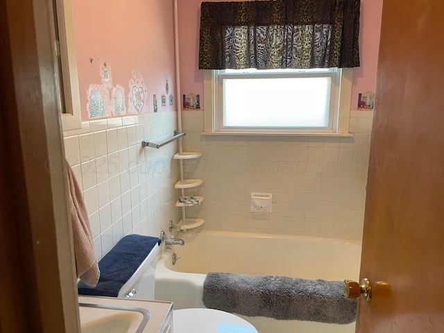 bathroom featuring toilet, a bathing tub, and a shower