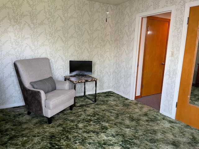 sitting room featuring wallpapered walls, baseboards, and carpet