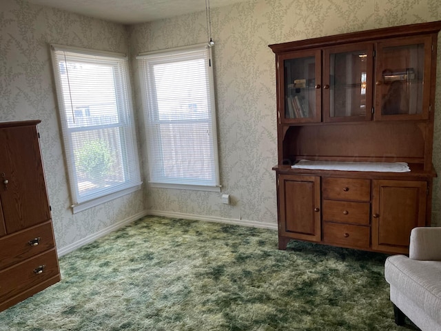 office space with baseboards, dark colored carpet, and wallpapered walls