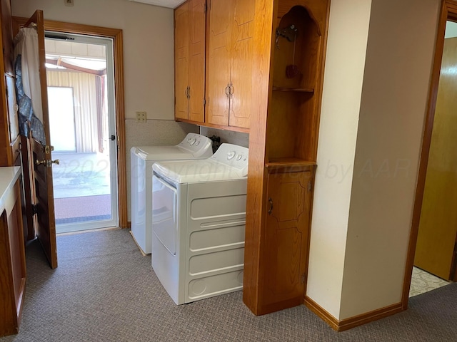 washroom with separate washer and dryer, baseboards, carpet, and cabinet space