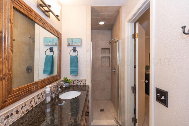 2314 Atkinsen St, Amarillo, TX 79106 - bathroom with a shower stall, vanity, and a textured wall