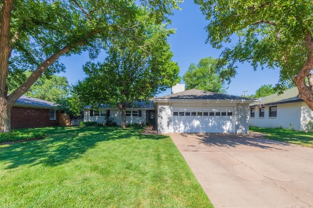 2314 Atkinsen St, Amarillo, TX 79106 - single story home with an attached garage, concrete driveway, a chimney, a front lawn, and brick siding