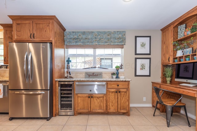 2314 Atkinsen St, Amarillo, TX 79106 - kitchen featuring freestanding refrigerator, wine cooler, a warming drawer, brown cabinets, and light tile patterned floors