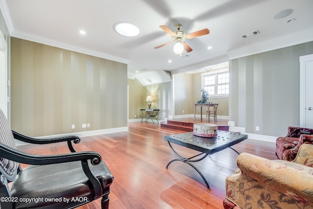 living room with ceiling fan, light hardwood / wood-style floors, and ornamental molding