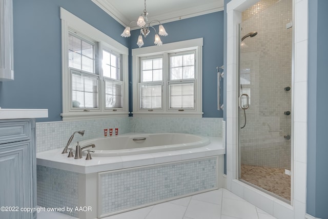 bathroom featuring plus walk in shower, tile patterned flooring, a notable chandelier, crown molding, and vanity