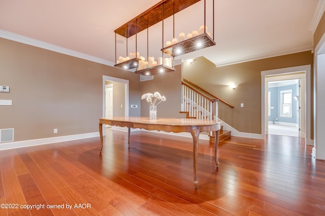 2223 S Ong St, Amarillo, TX 79109 - dining space with stairway, visible vents, baseboards, ornamental molding, and wood finished floors