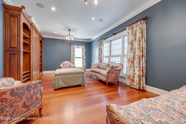 bedroom featuring a chandelier, hardwood / wood-style floors, and crown molding