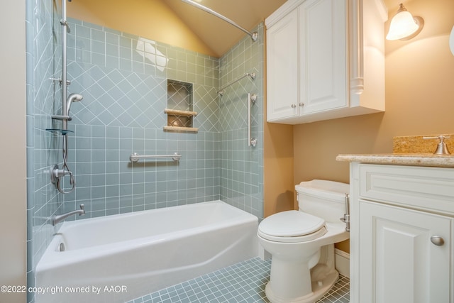 full bathroom with tile patterned floors, vanity, vaulted ceiling, and toilet