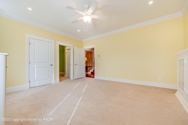 unfurnished bedroom featuring crown molding, ceiling fan, and light carpet