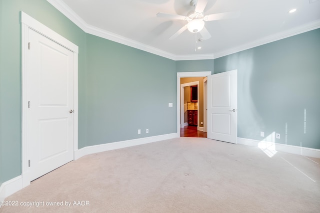 unfurnished bedroom with carpet floors, ceiling fan, and crown molding