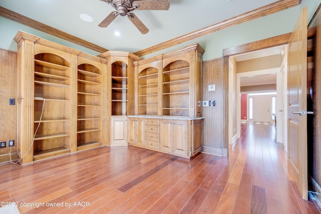 unfurnished office featuring ceiling fan, hardwood / wood-style floors, and ornamental molding